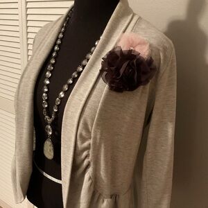 Beautiful light gray sweater, pink and black flowers. Necklace not for sale.